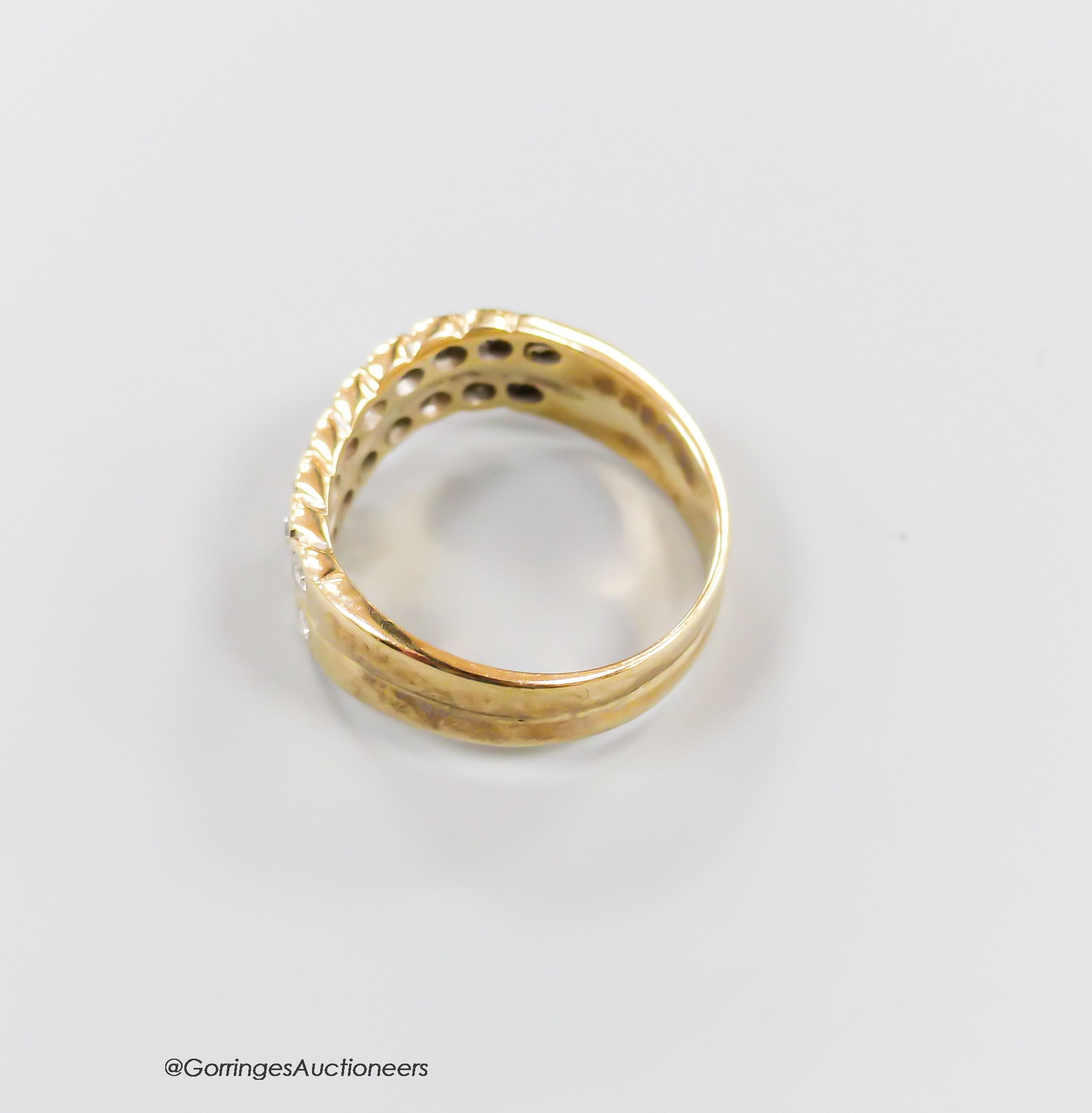 A modern 9ct gold and two row diamond set half hoop ring, size O, gross 4.6 grams.